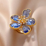 Bague ouverte acier doré, zircon bleu