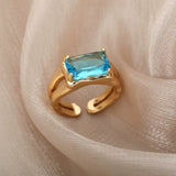 Bague ouverte acier doré, zircon bleu