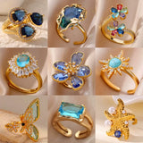 Bague ouverte acier doré, zircon bleu