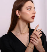Collier pendentif zircon noir, acier doré