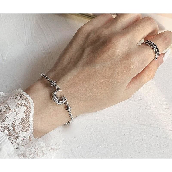 Bracelet demi lune en acier avec perles grises 